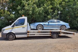 Emergency car recovery London — Aston Martin on a flatbed tow truck