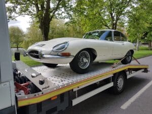 Classic car recovery London — Jaguar E-Type secured on a flatbed tow truck