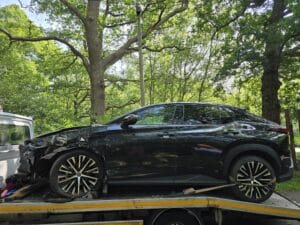 Electric vehicle recovery London — damaged Lexus EV secured on a flatbed with wheel skates after a collision