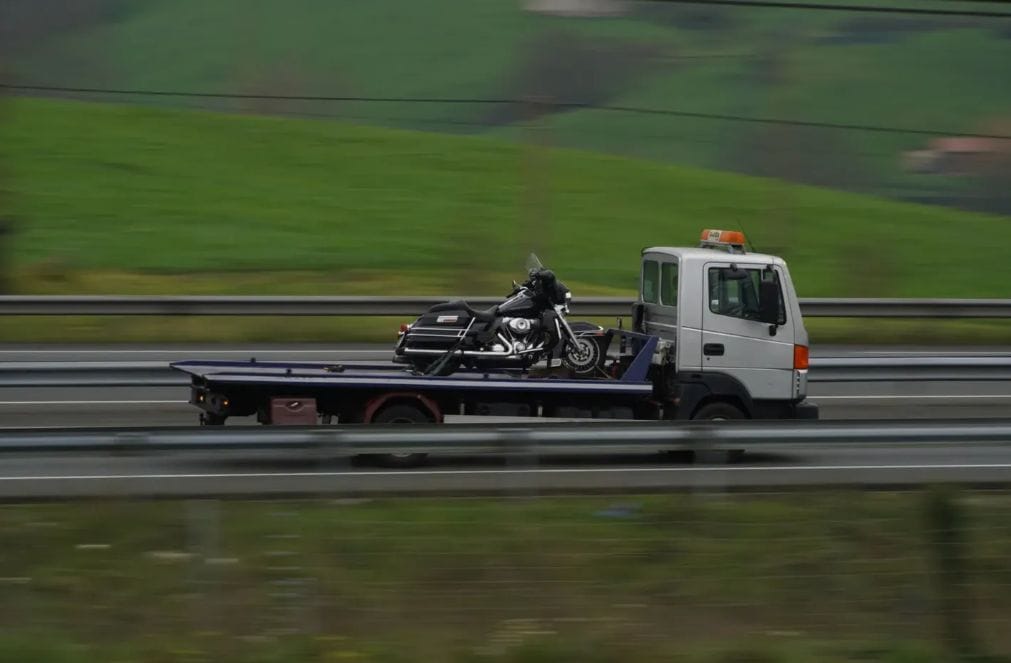 Flatbed tow truck carrying a motorbike in London — emergency car recovery London by London Auto Towing