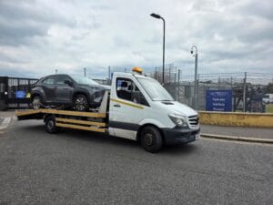 Police compound recovery London — flatbed collecting a car from the Metropolitan Police Perivale Vehicle Pound