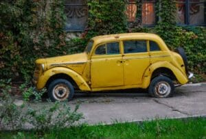 Scrap car collection London — old yellow non-runner ready for flatbed pickup