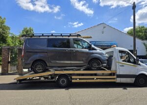 Van recovery London — commercial van secured on a flatbed tow truck