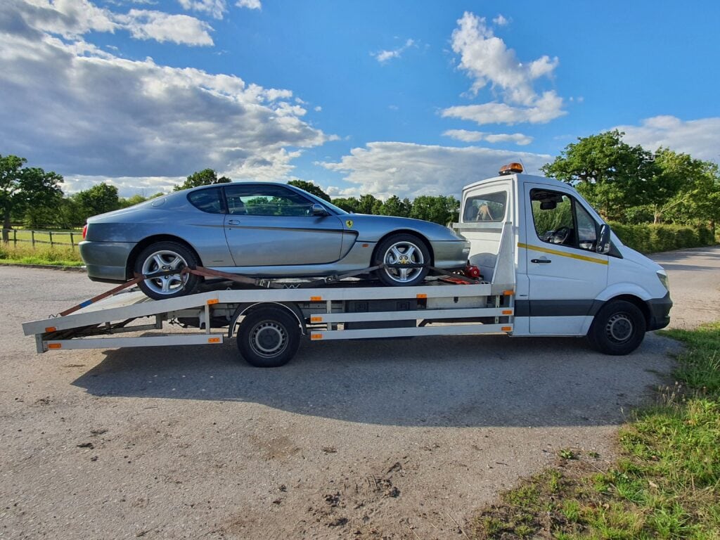 Flatbed towing service London transporting a Ferrari safely on a recovery truck