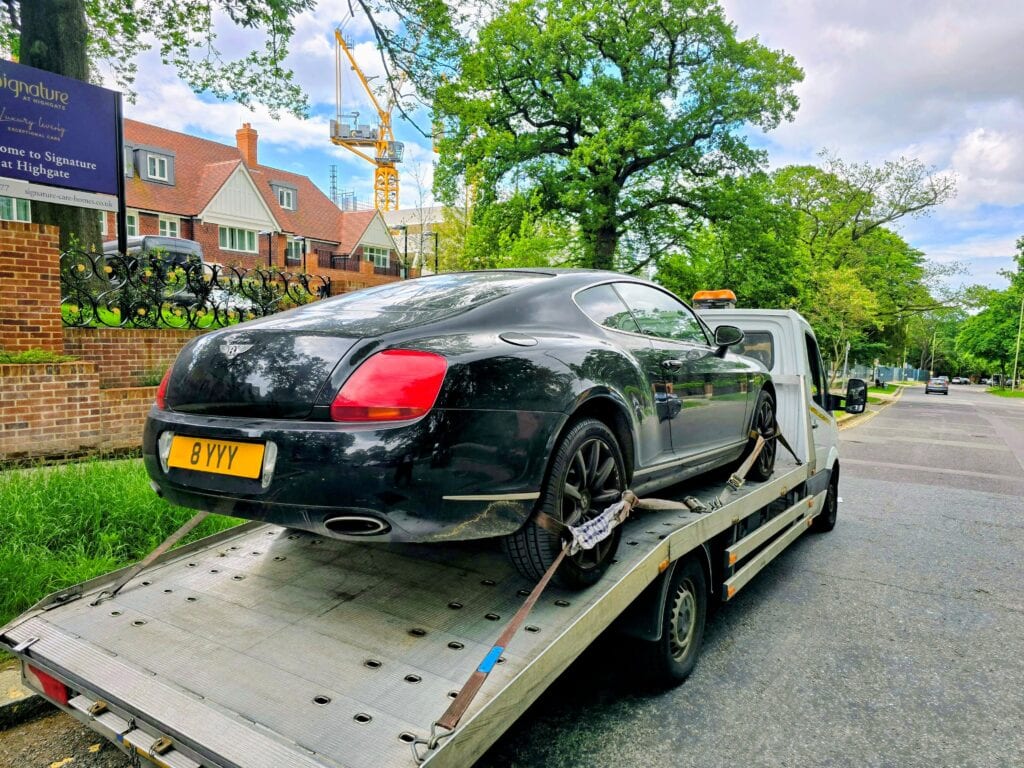 Bentley on flatbed recovery truck – high value vehicle towing service London by London Auto Towing