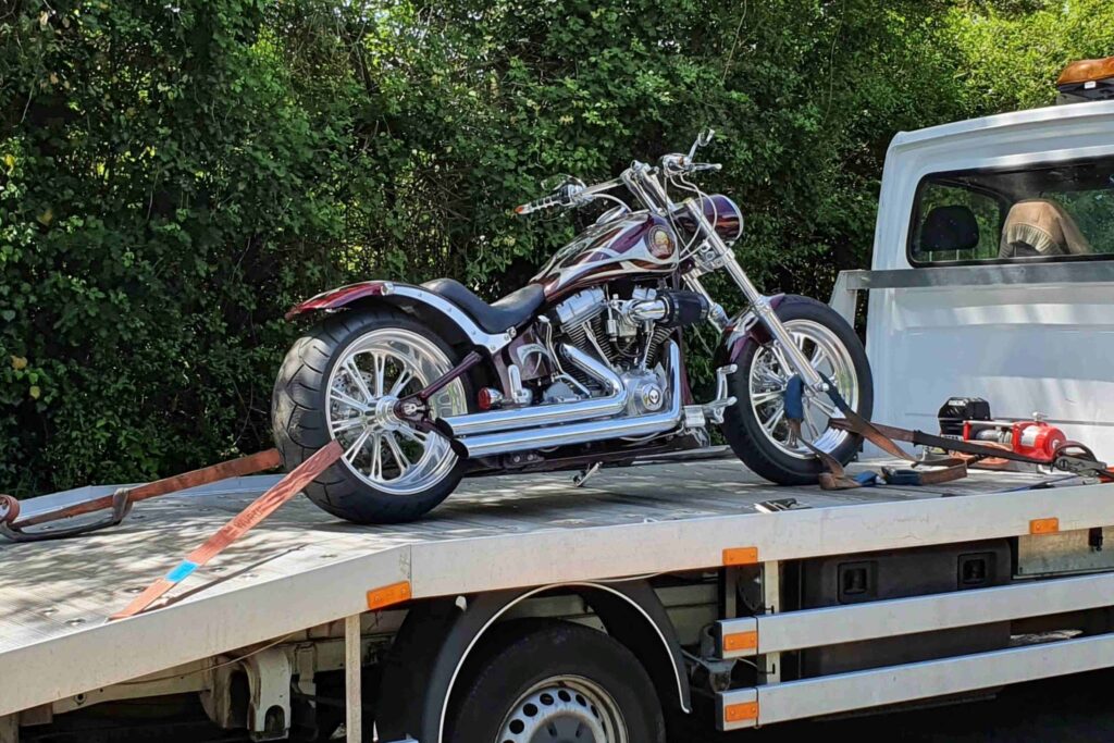 motorbike recovery London — motorcycle secured on flatbed towing service after breakdown