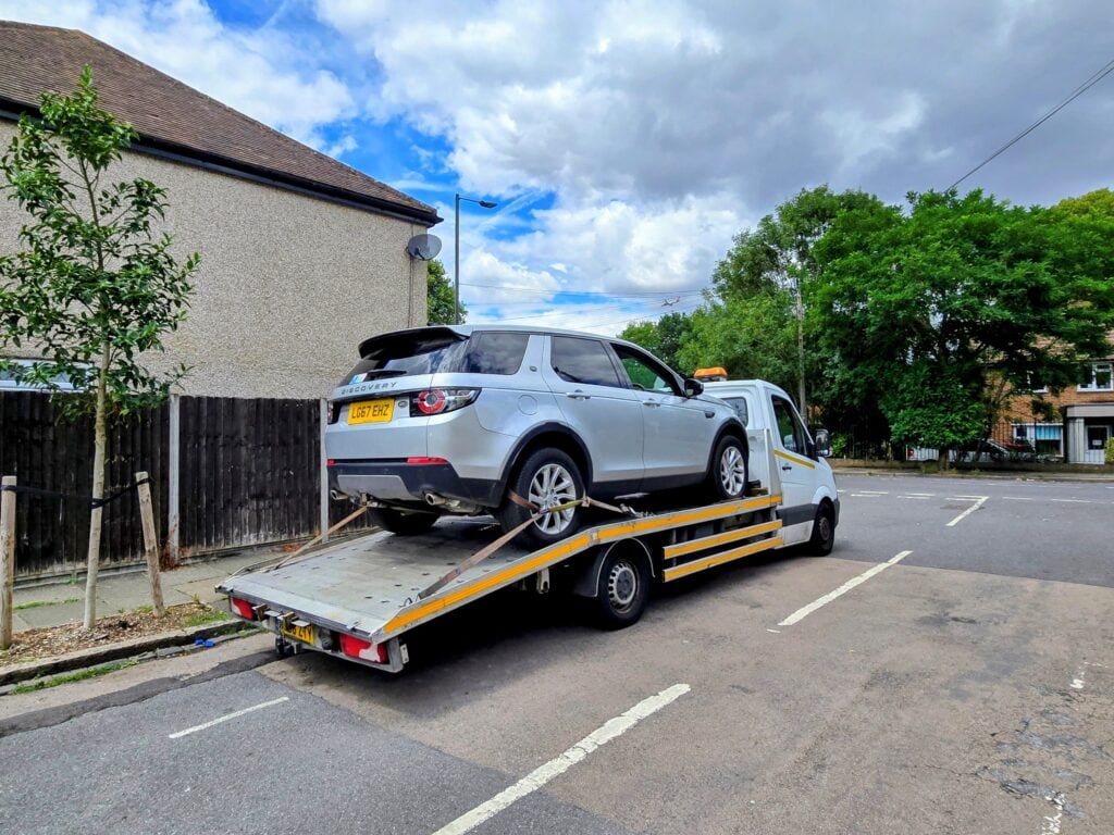 Land Rover Discovery recovered on flatbed tow truck by London Auto Towing