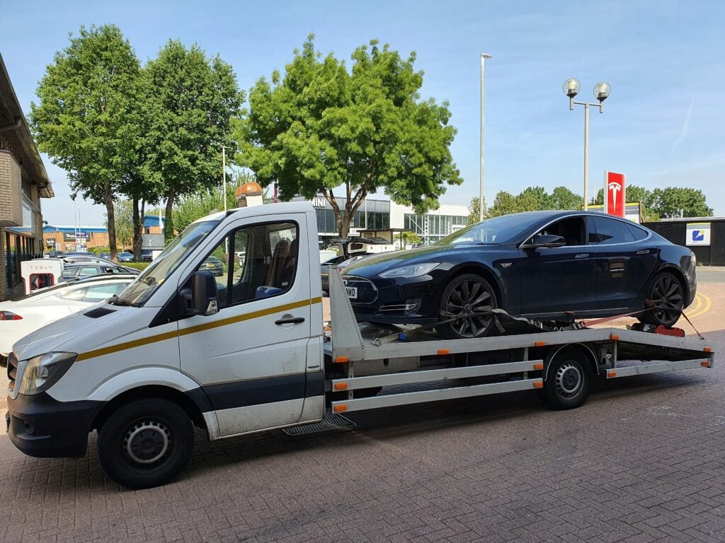 electric vehicle recovery London — Tesla on flatbed tow truck with EV-safe loading