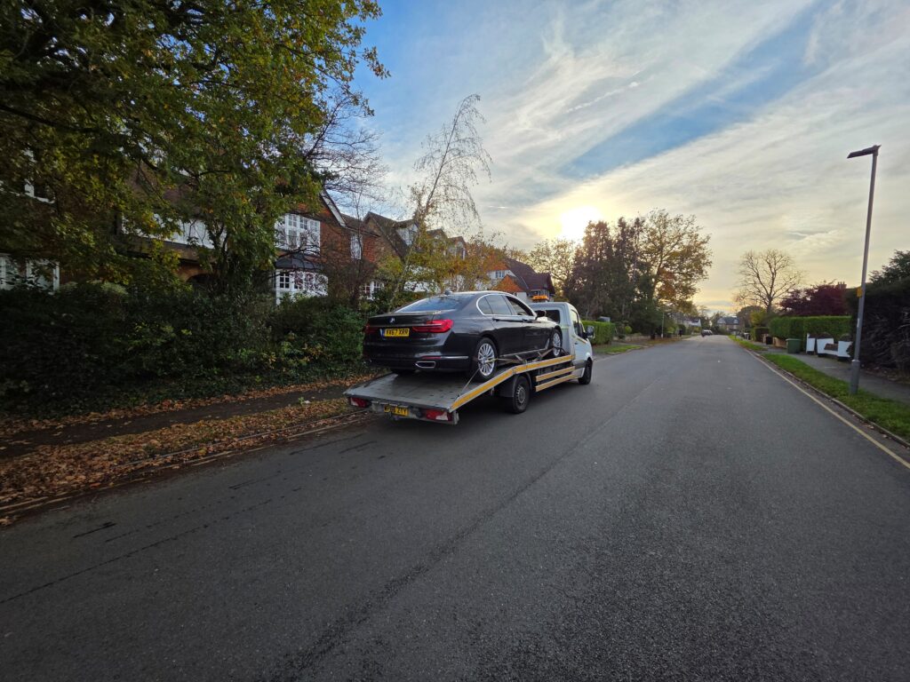 BMW 7 Series on a white flatbed tow truck by London Auto Towing during high-value car recovery in West London.