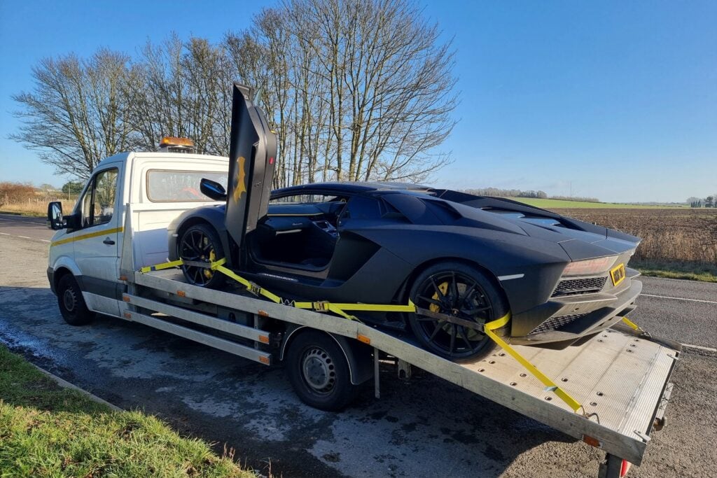 High value car towing London — Lamborghini safely loaded on flatbed tow truck by London Auto Towing