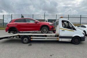 Damaged Mercedes GLA being recovered on our flatbed recovery truck during a police compound electric vehicle recovery in London.