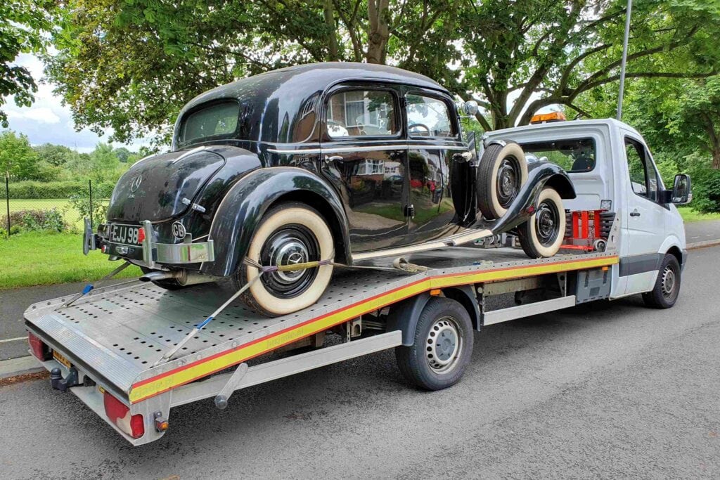 Vintage Mercedes safely loaded on flatbed tow truck – high value car recovery by London Auto Towing.