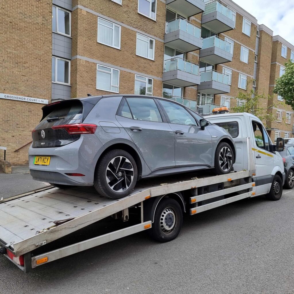 Volkswagen ID.3 electric car loaded onto a flatbed recovery truck in London