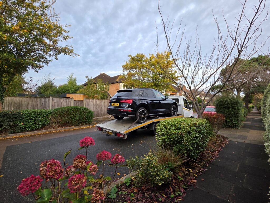 Audi Q5 plug-in hybrid SUV recovered on a flatbed tow truck for plug-in hybrid vehicle recovery in London