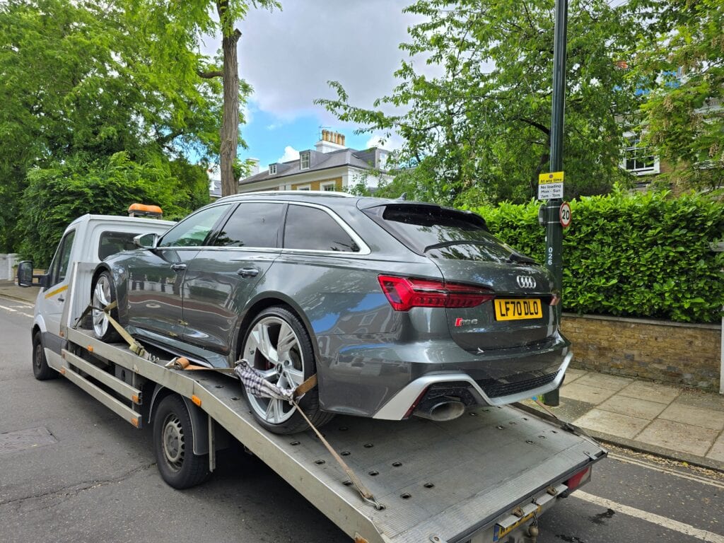 Audi RS6 securely loaded on our flatbed recovery truck during a high value performance car recovery in London