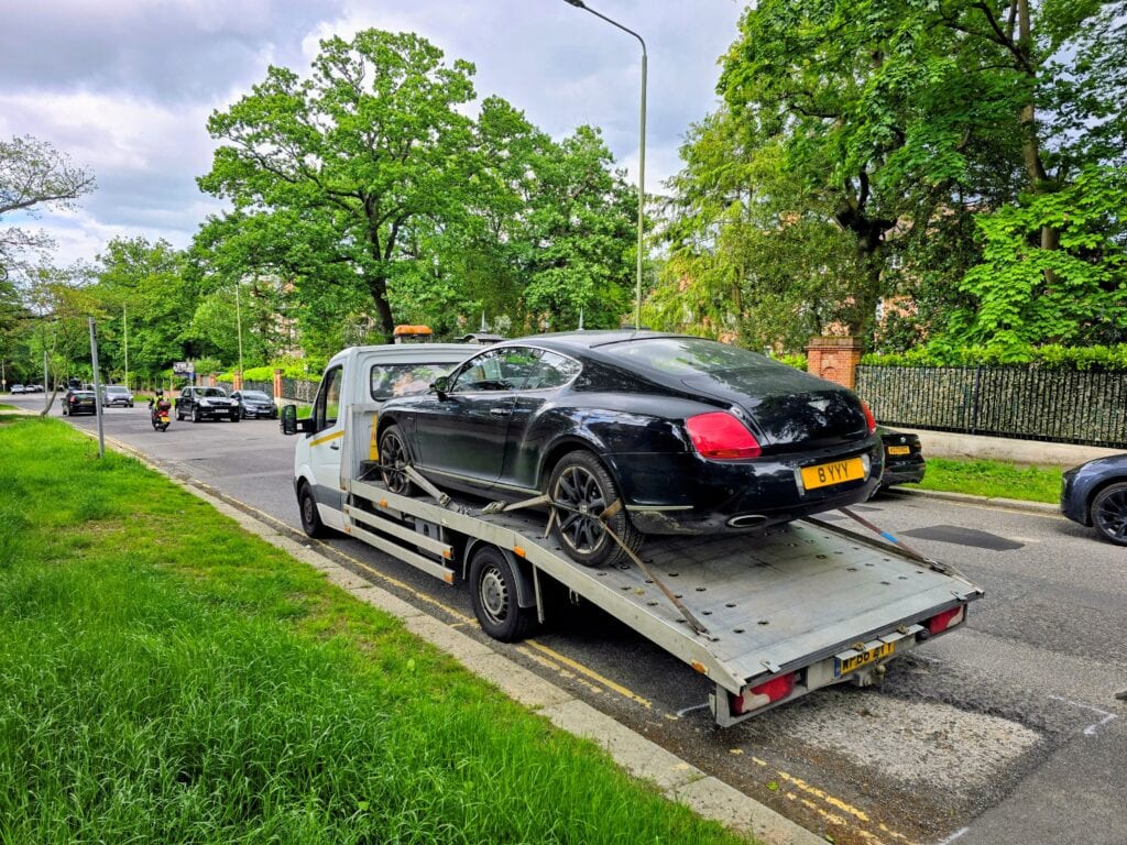 Black Bentley Continental GT recovered by our flatbed truck Representing over 20 years of expertise in the high value towing industry.