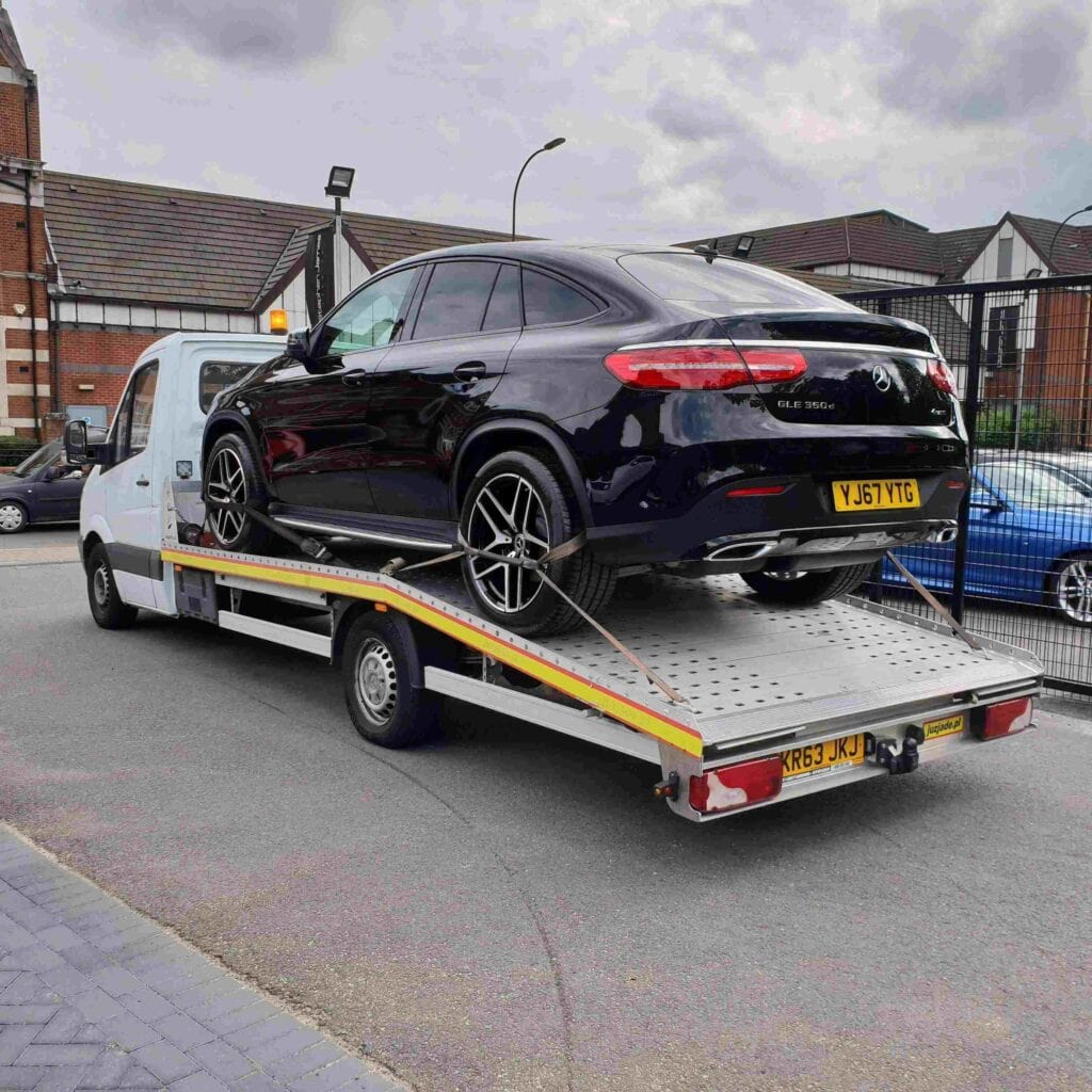 London Auto Towing flatbed recovery truck loading a high value Mercedes SUV for breakdown recovery.