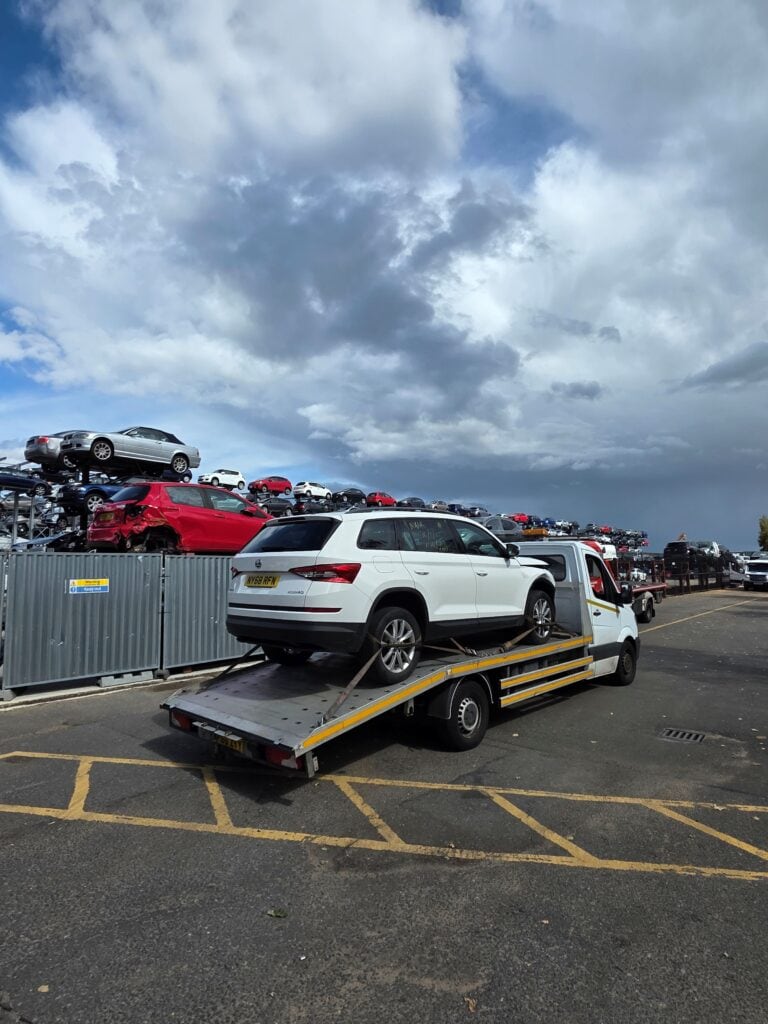 Car bought from auction loaded on our flatbed tow truck as part of our we buy any cars service.