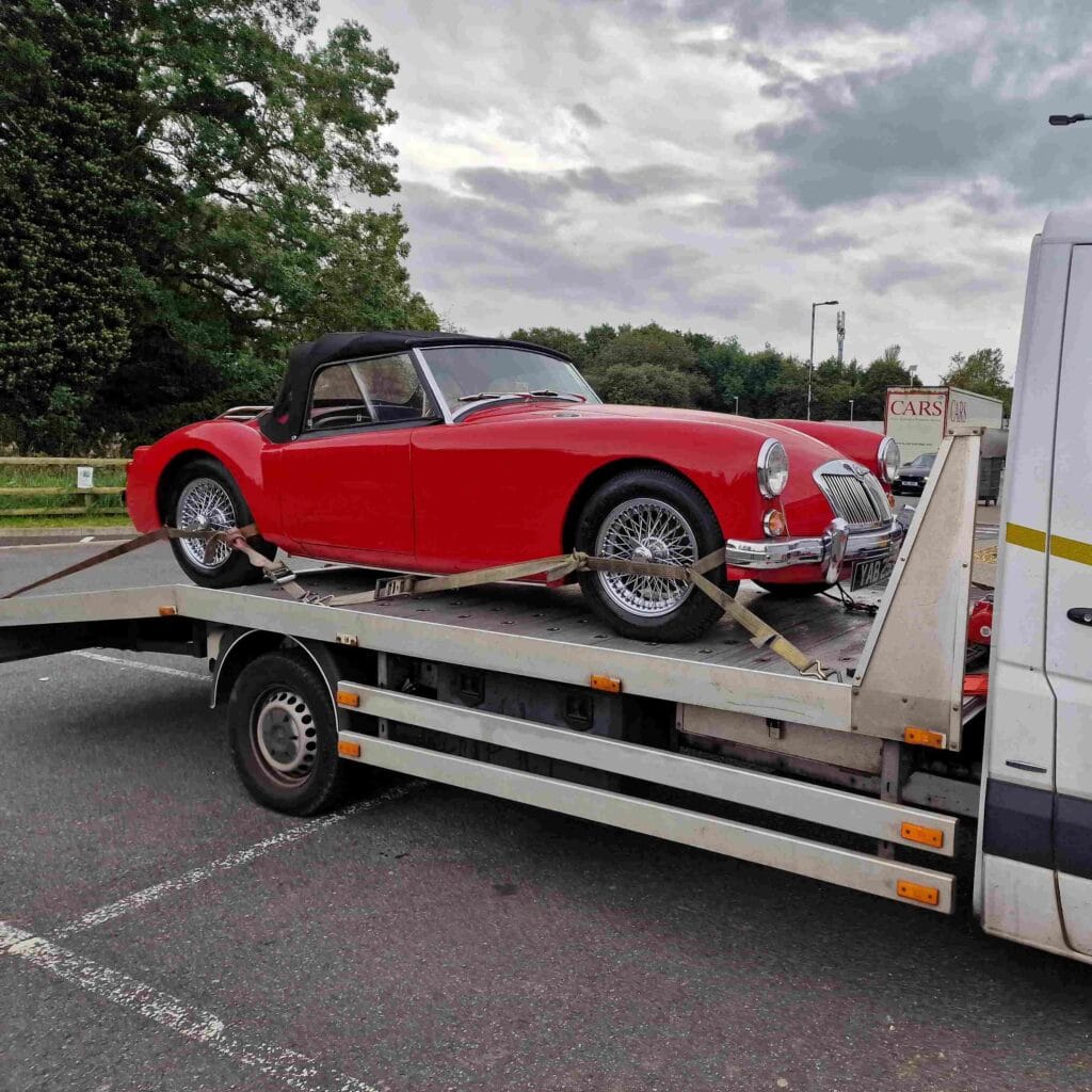 Classic MG sports car secured on our flatbed tow truck for careful car recovery in London
