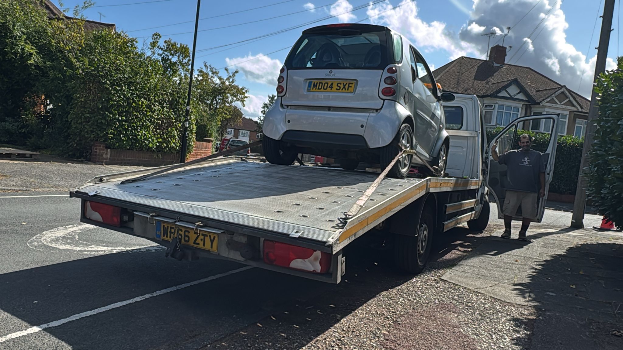 Smart car being loaded onto a London Auto Towing recovery truck for a local sell your car customer.