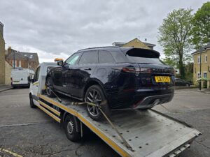Range Rover Velar plug-in hybrid being recovered on our flatbed recovery truck during a hybrid car recovery job in London.