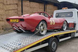 High value car recovery for a Marcos-style performance show car, secured level on our flatbed recovery truck for specialist transport.