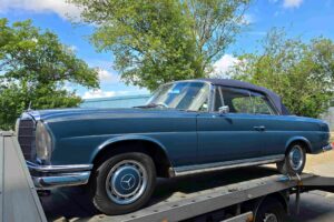 Classic car recovery for a Mercedes 280 SE Cabriolet, secured level on our flatbed towing service during high value transport in London.