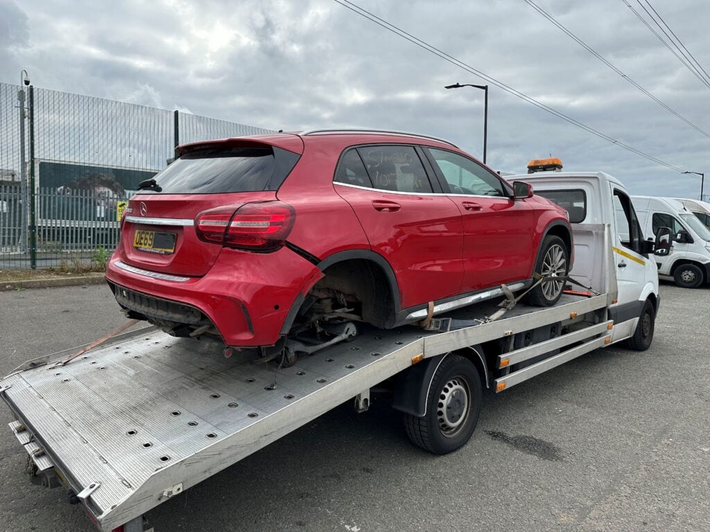 Mercedes-Benz GLA accident recovery from police compound secured on flatbed tow truck in London