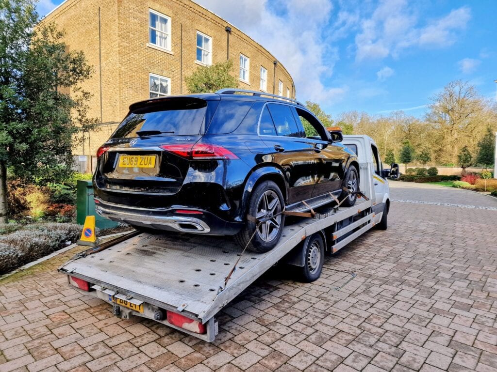 Mercedes GLE 4MATIC secured on a flatbed tow truck for high value car recovery service and delivery to the new owner in London.