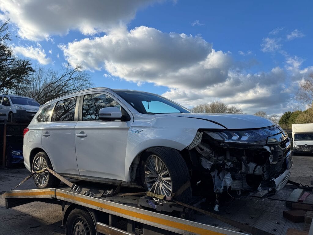 Mitsubishi Outlander PHEV hybrid accident recovery on flatbed tow truck using wheel skates in London