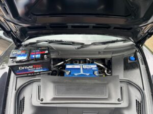 Jump start and battery support setup on a Porsche 911, with auxiliary batteries connected for high value car recovery in London.