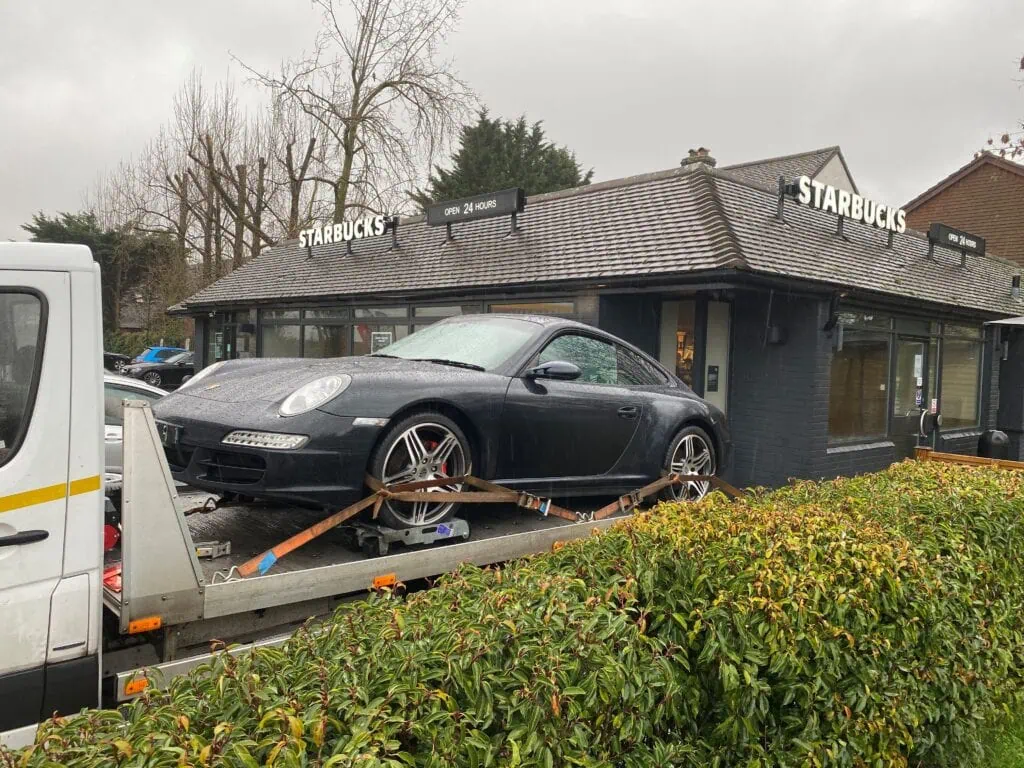 Porsche 911 non-runner recovery on flatbed tow truck using wheel skates in London