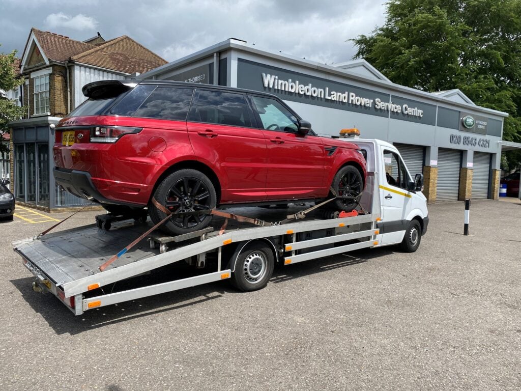Range Rover Sport non-runner recovery on flatbed tow truck using four wheel skates in Wimbledon