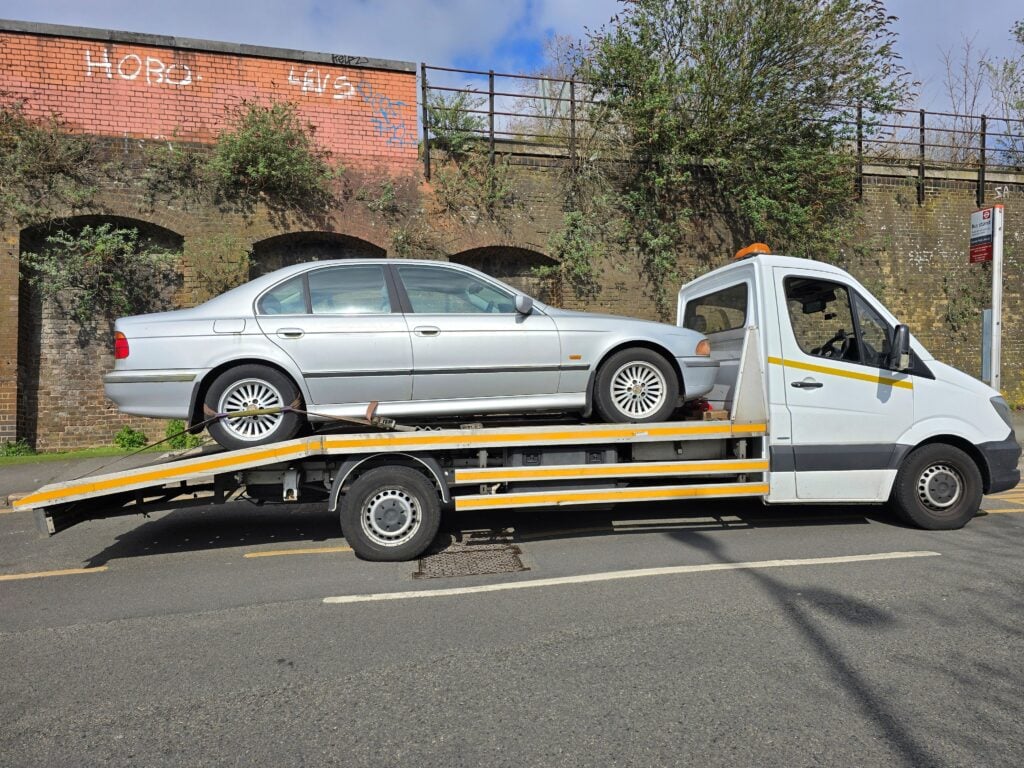 BMW 5 Series being collected on our flatbed tow truck for scrap car collection service