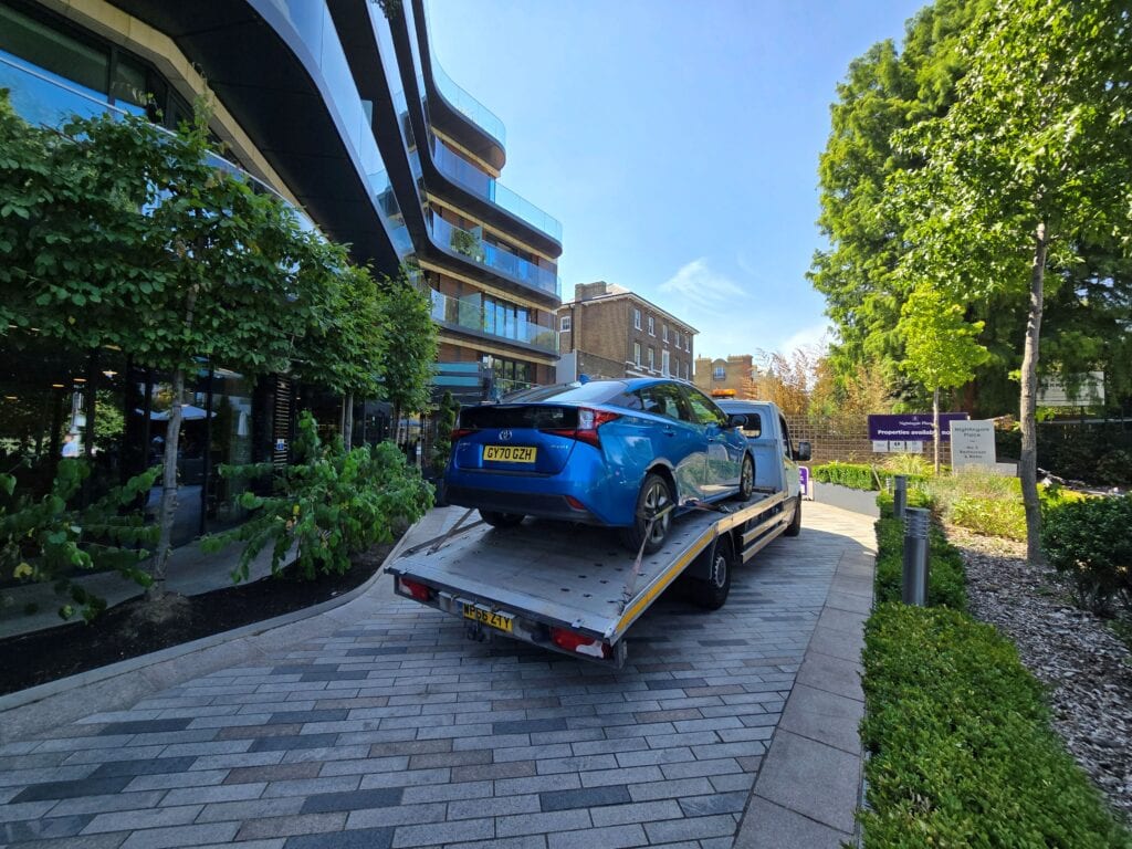 Toyota Prius hybrid vehicle transported from France back to London on a flatbed recovery truck