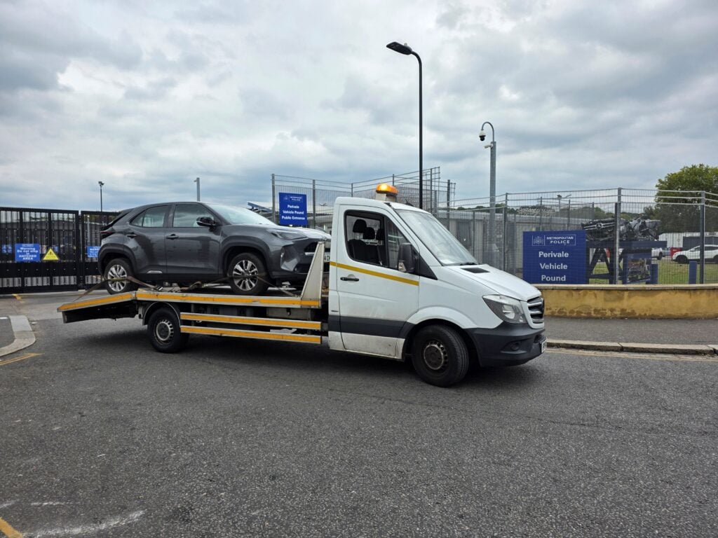 Toyota Yaris Hybrid collected from Perivale Vehicle Pound for police compound recovery in London and loaded onto a flatbed recovery truck