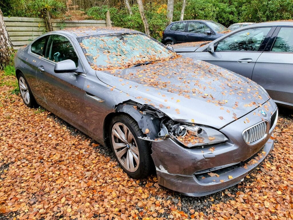 Damaged BMW 6 Series awaiting scrap car collection in London
