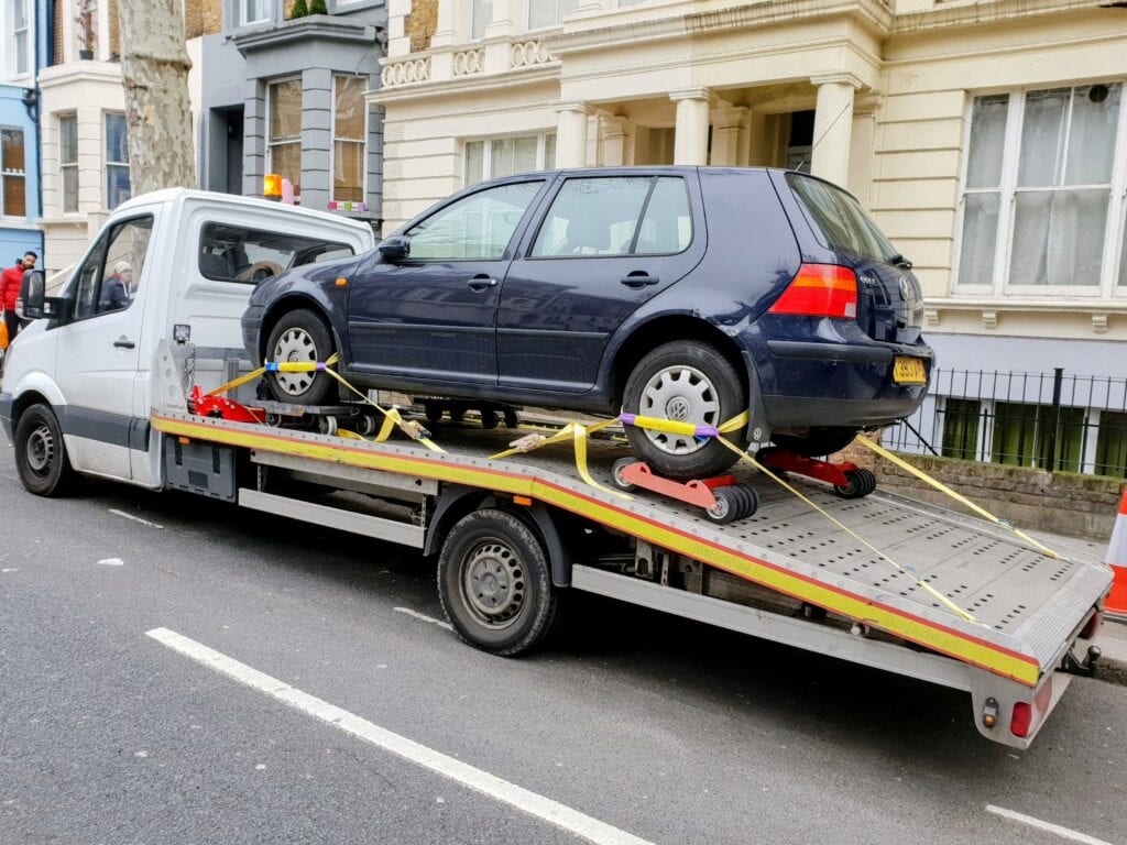 Volkswagen Golf no keys recovery on flatbed tow truck using four wheel skates in London
