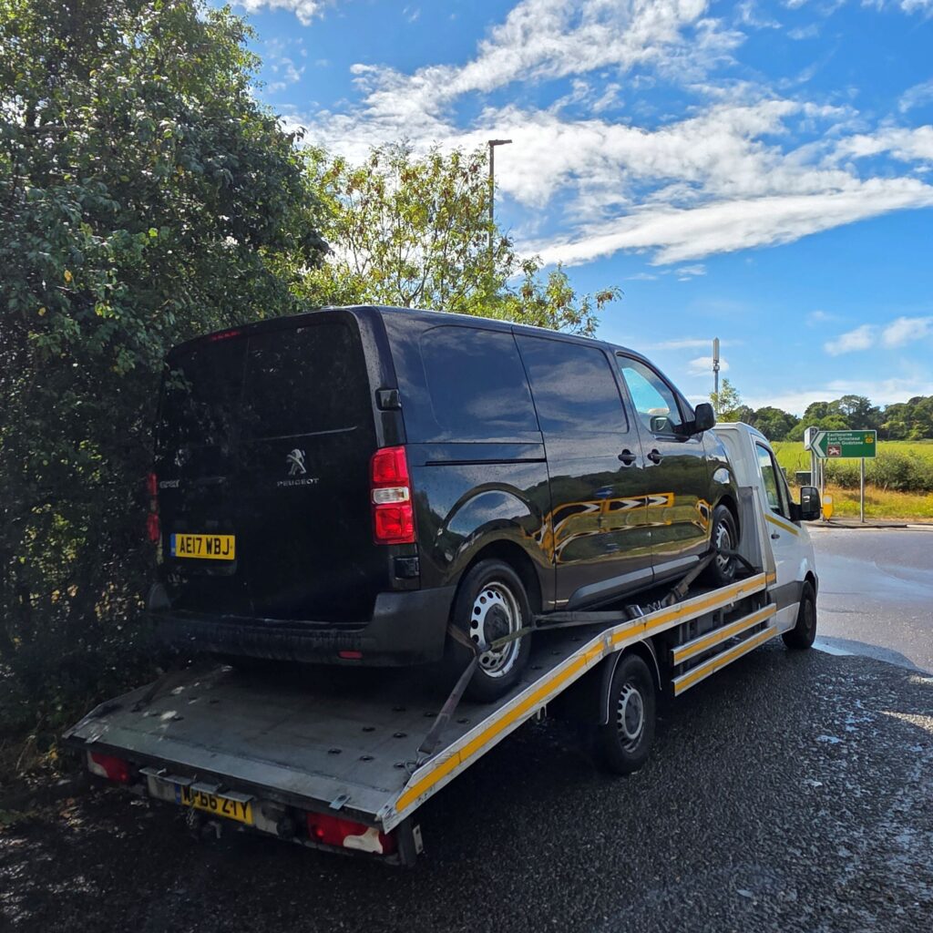 We buy any vans with free collection, Peugeot Expert loaded onto our flatbed tow truck in London.