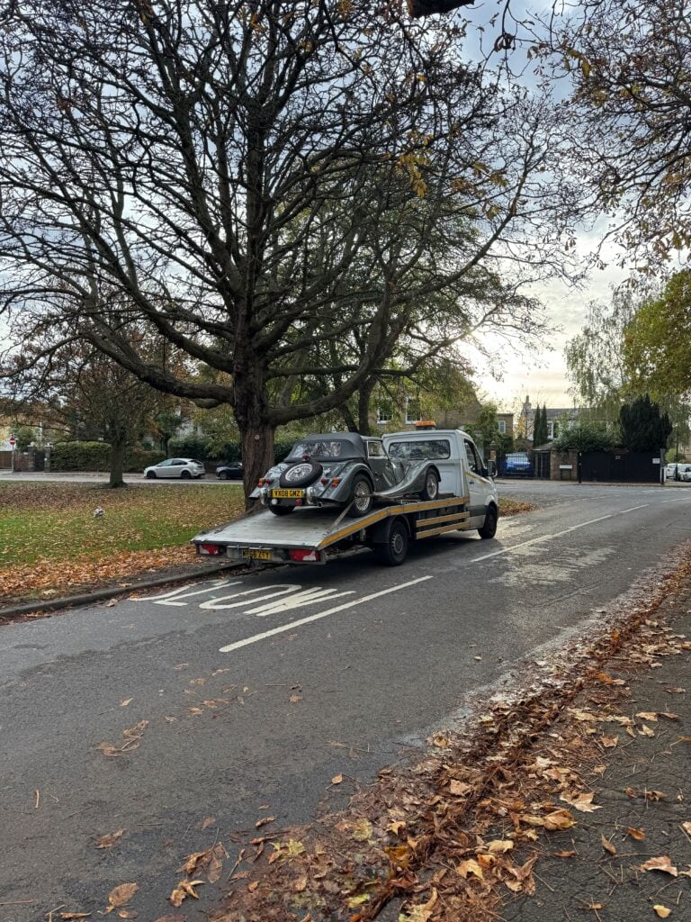 Classic car collected on a flatbed tow truck as part of our we buy any cars and vans service in London.