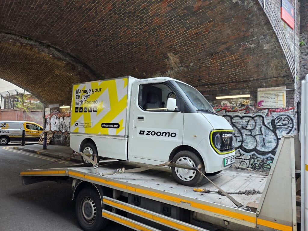 Zoomo electric van recovered on a flatbed tow truck for fleet breakdown recovery service in London