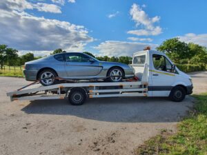 Prestige silver Ferrari loaded on a flatbed recovery truck for professional high value car recovery in Kingston.