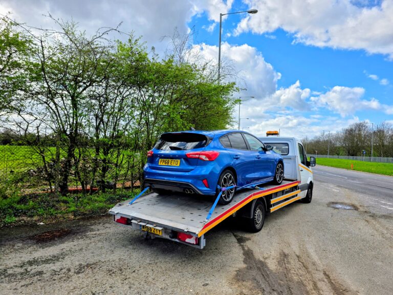 Ford Focus ST Line being transported by London Auto Towing during expert car recovery Twickenham on a flatbed recovery truck.