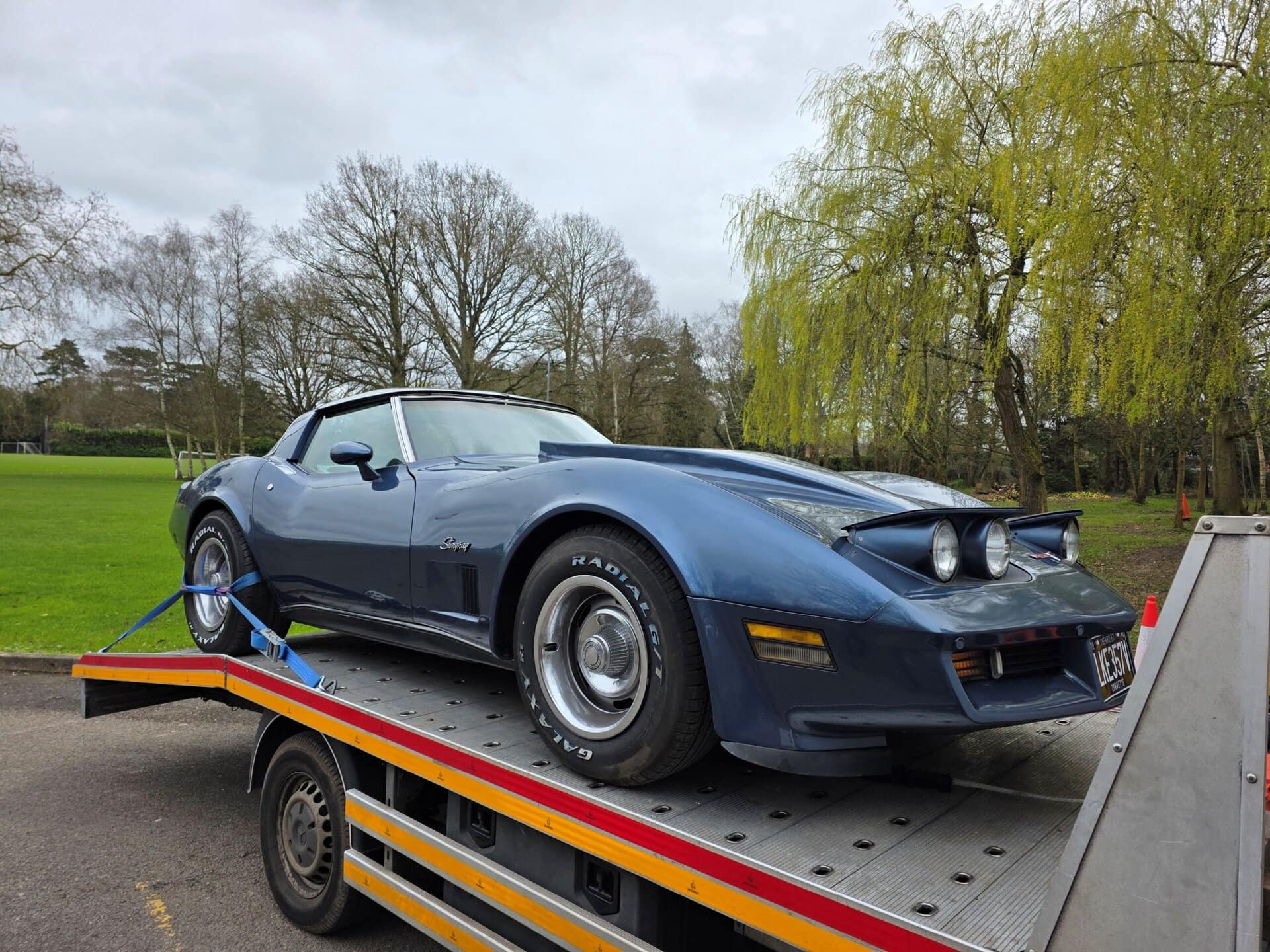 Classic Chevrolet Corvette C3 Stingray loaded on a flatbed recovery truck for professional car recovery London and police compound towing service.