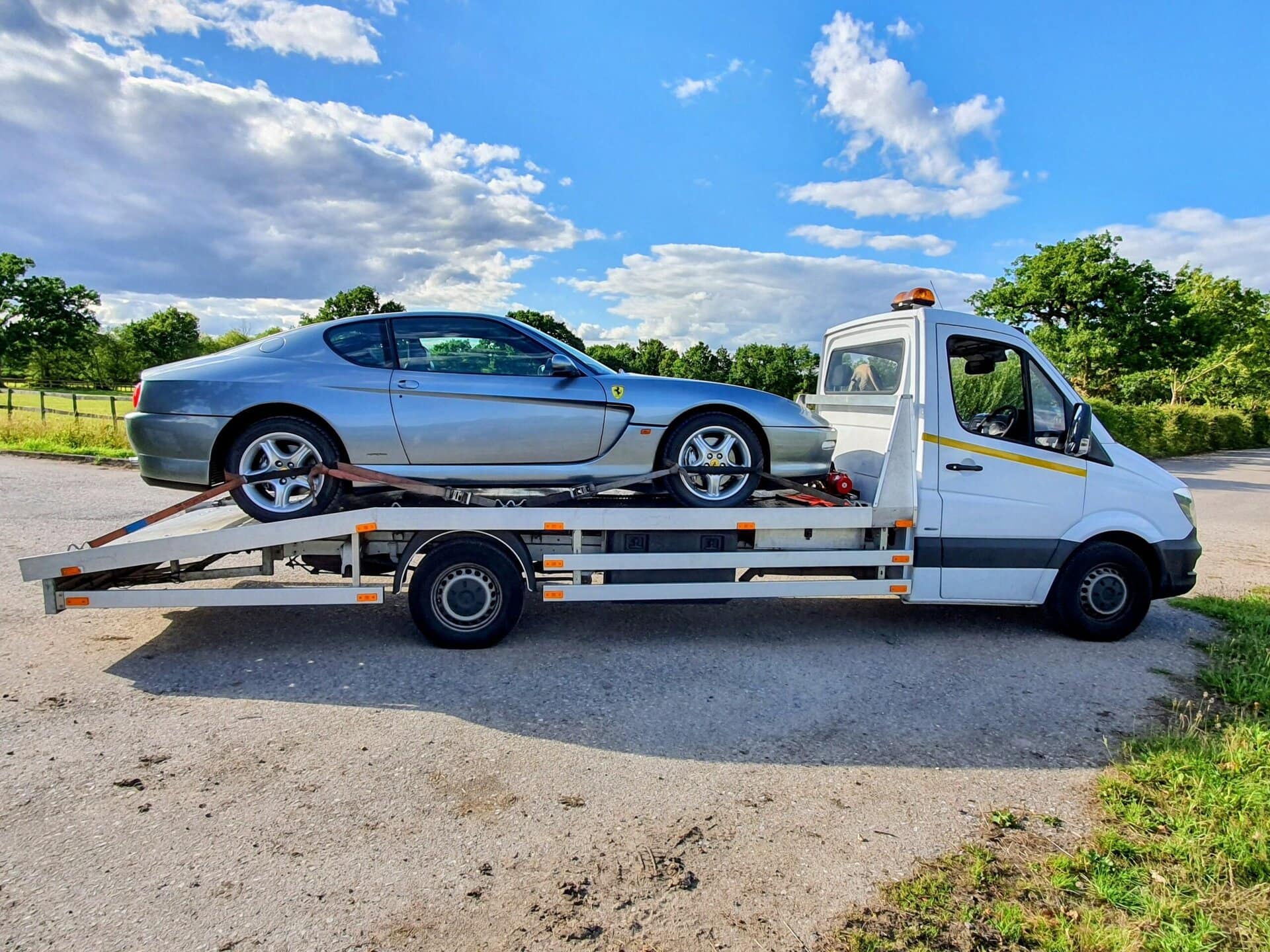 Flatbed recovery truck transporting Ferrari for professional car recovery service in Twickenham