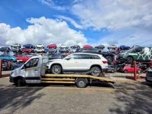 Professional impound car recovery of a white Skoda Kodiaq non-runner from a police compound storage yard in Isleworth using a flatbed tow truck.