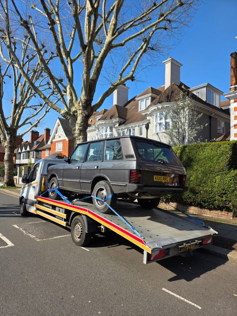 Classic Range Rover on flatbed tow truck during car recovery Twickenham