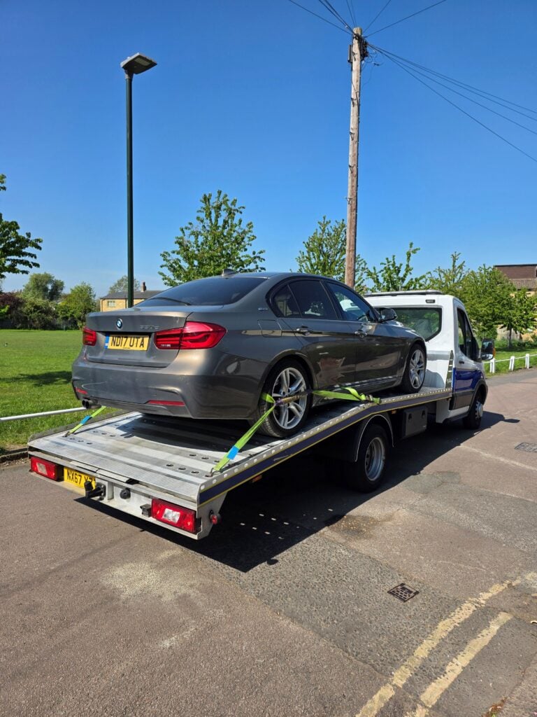 BMW 330e hybrid on a flatbed tow truck for professional hybrid car recovery Fulham in the SW6 area.