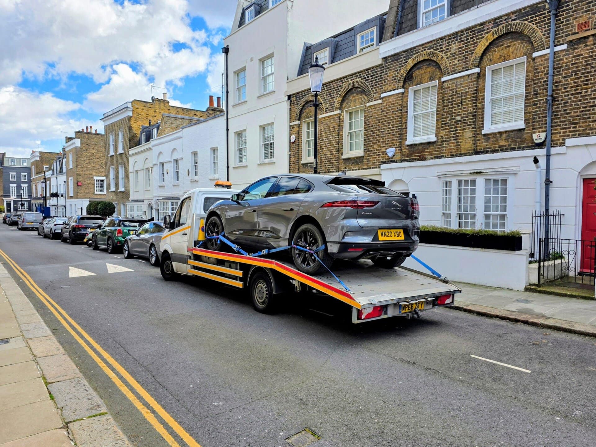 Grey Jaguar I-PACE electric car on a flatbed tow truck for specialist electric car recovery Fulham and breakdown recovery in SW6.