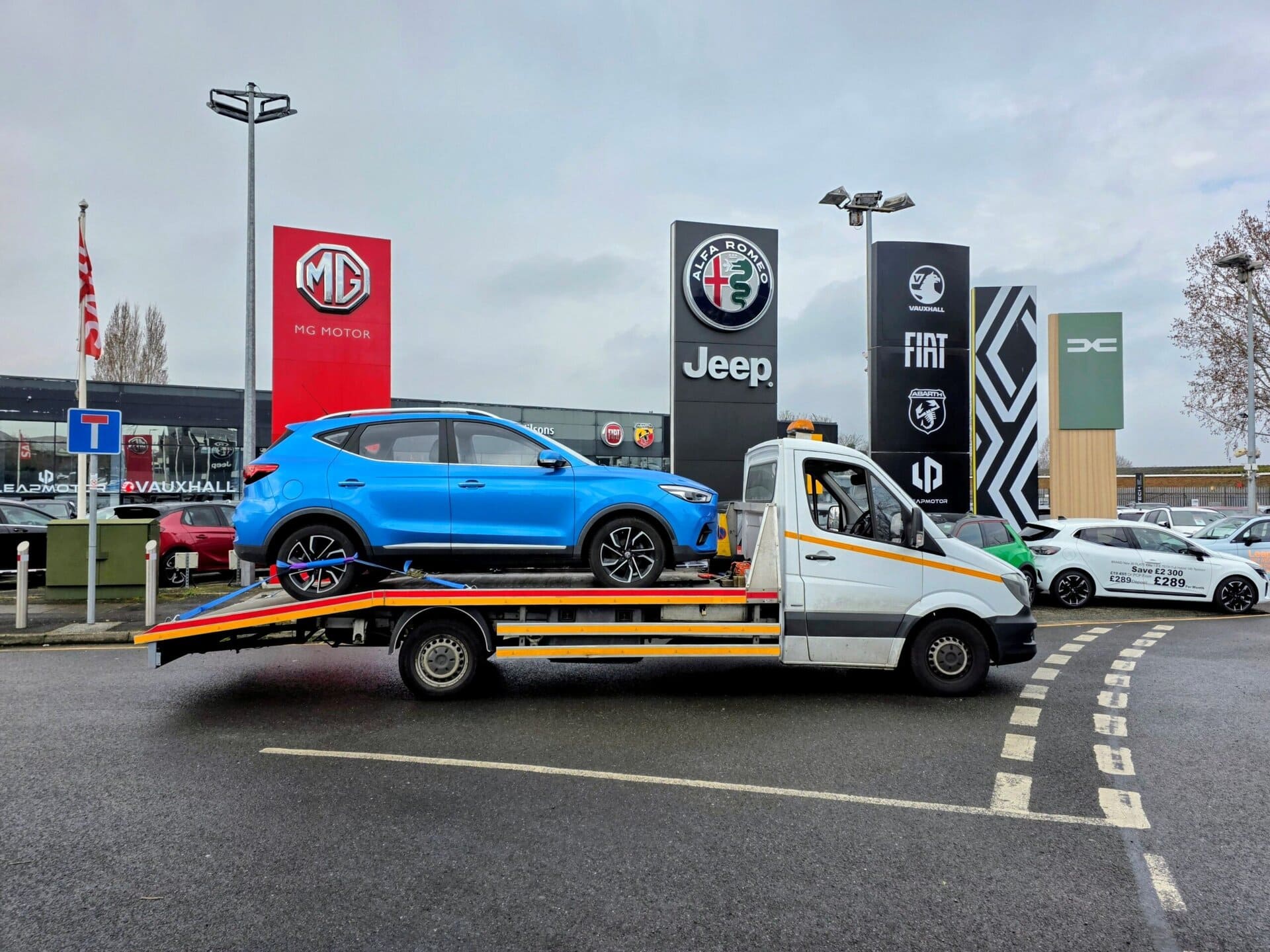 Blue MG ZS on a flatbed recovery truck for professional car recovery Wimbledon service and emergency breakdown recovery in SW19 area.